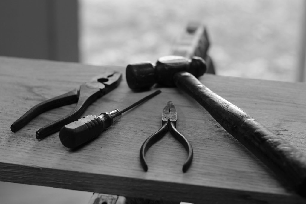 Black and white picture of tools on a bench