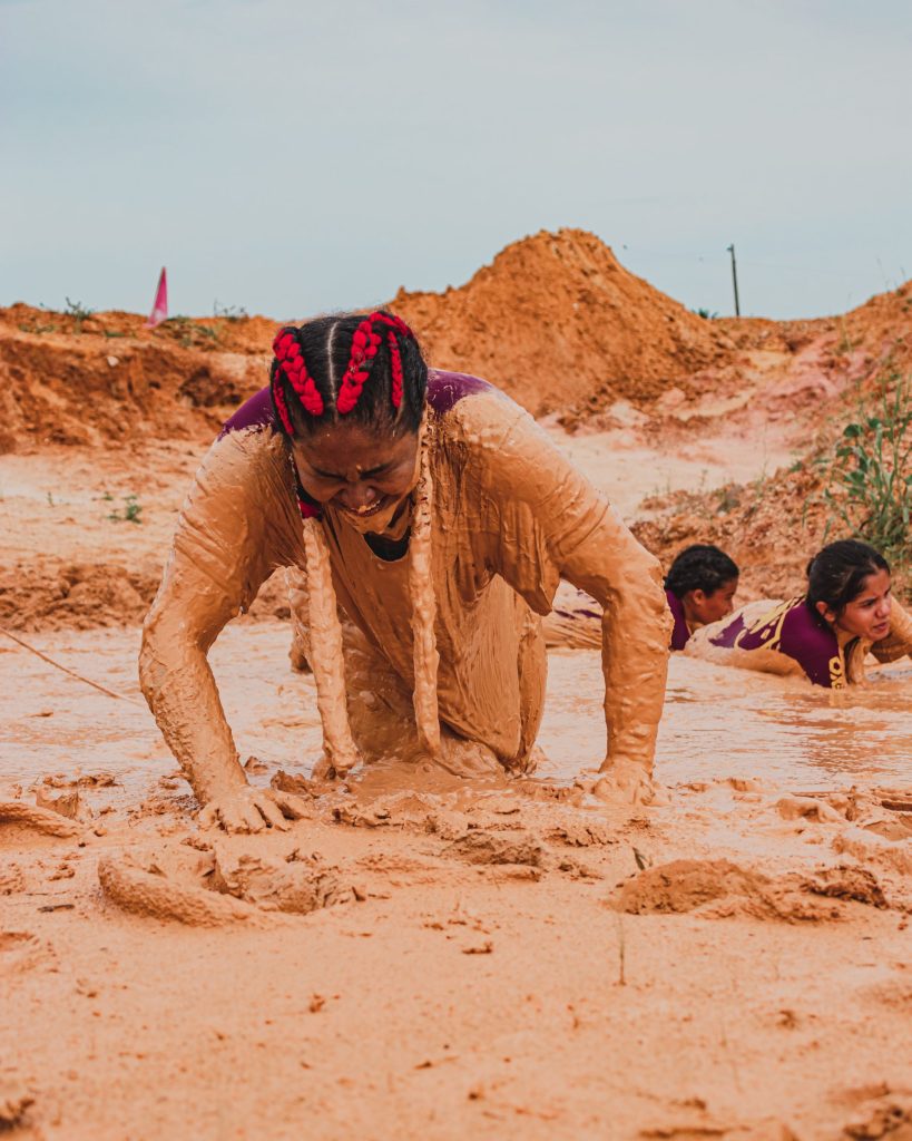 Woman crawling through mud