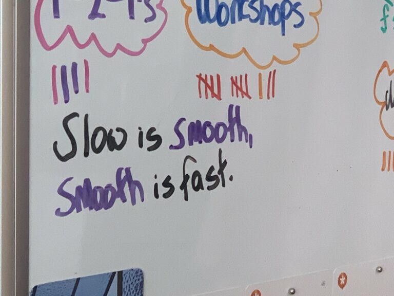 My whiteboard that says "Slow is Smooth and Smooth is fast"