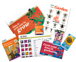 A selection of items included in an RHS subscription fanned out. For example a magazine cover, inside magazine layout and seed packets.